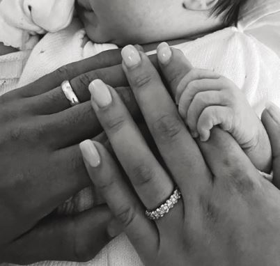Moise Ake son Nathan Ake and daughter-in-law Kaylee holding the hand of their newly born baby girl